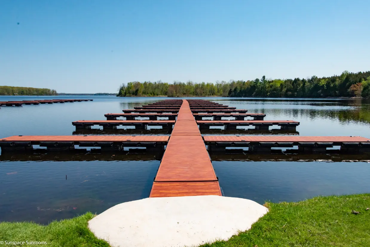 Aluma-Dock modular floating dock system extending into a calm lake with multiple slips