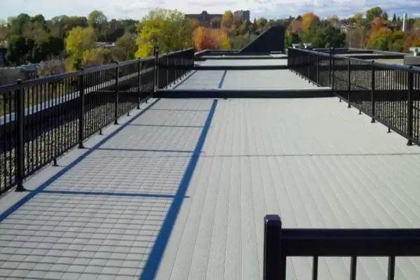 Light grey AlumaDeck aluminium decking rooftop walkway with black picket safety railings