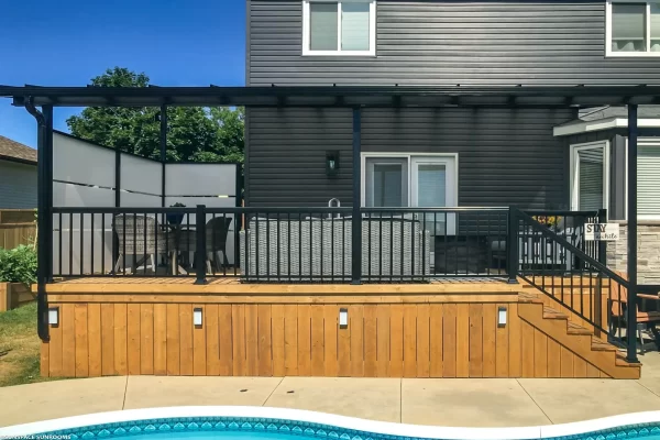 Sunspace LakeField SunWall and patio cover installed on wooden deck above swimming pool