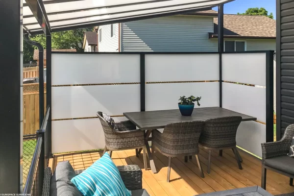 Sunspace LakeField SunWall and patio cover installed over outdoor wooden deck dining space