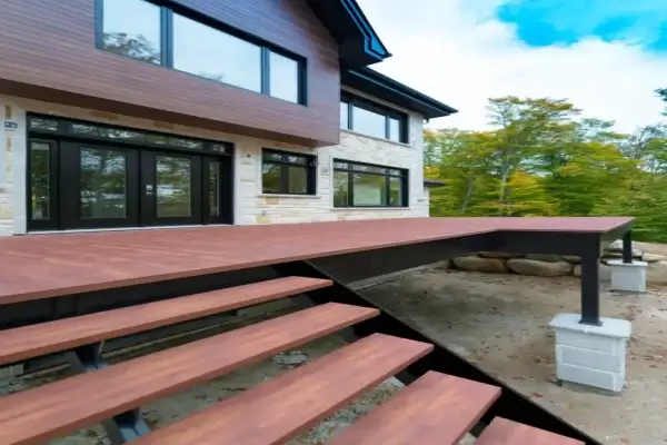 Modern wood grain elevated decking system with wide access stairs attached to a contemporary home